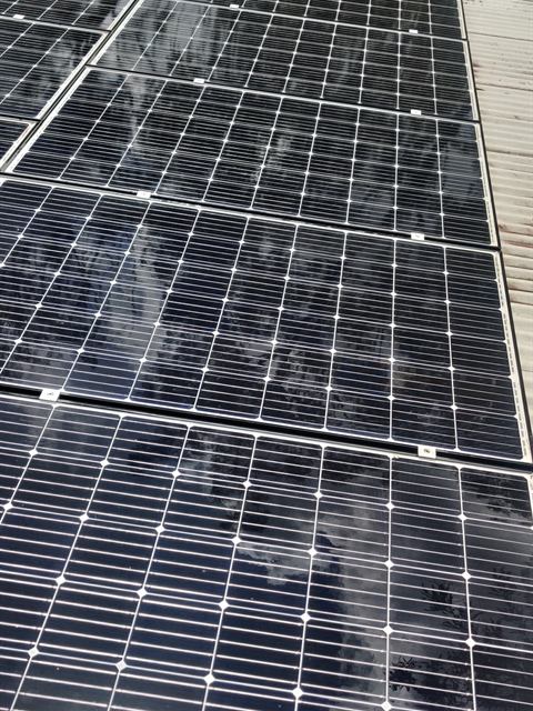 Long solar array on a metal roof after cleaning